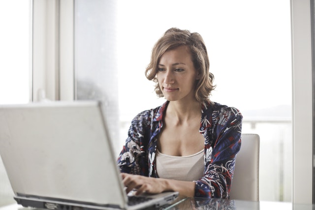 Woman sitting at laptop computer